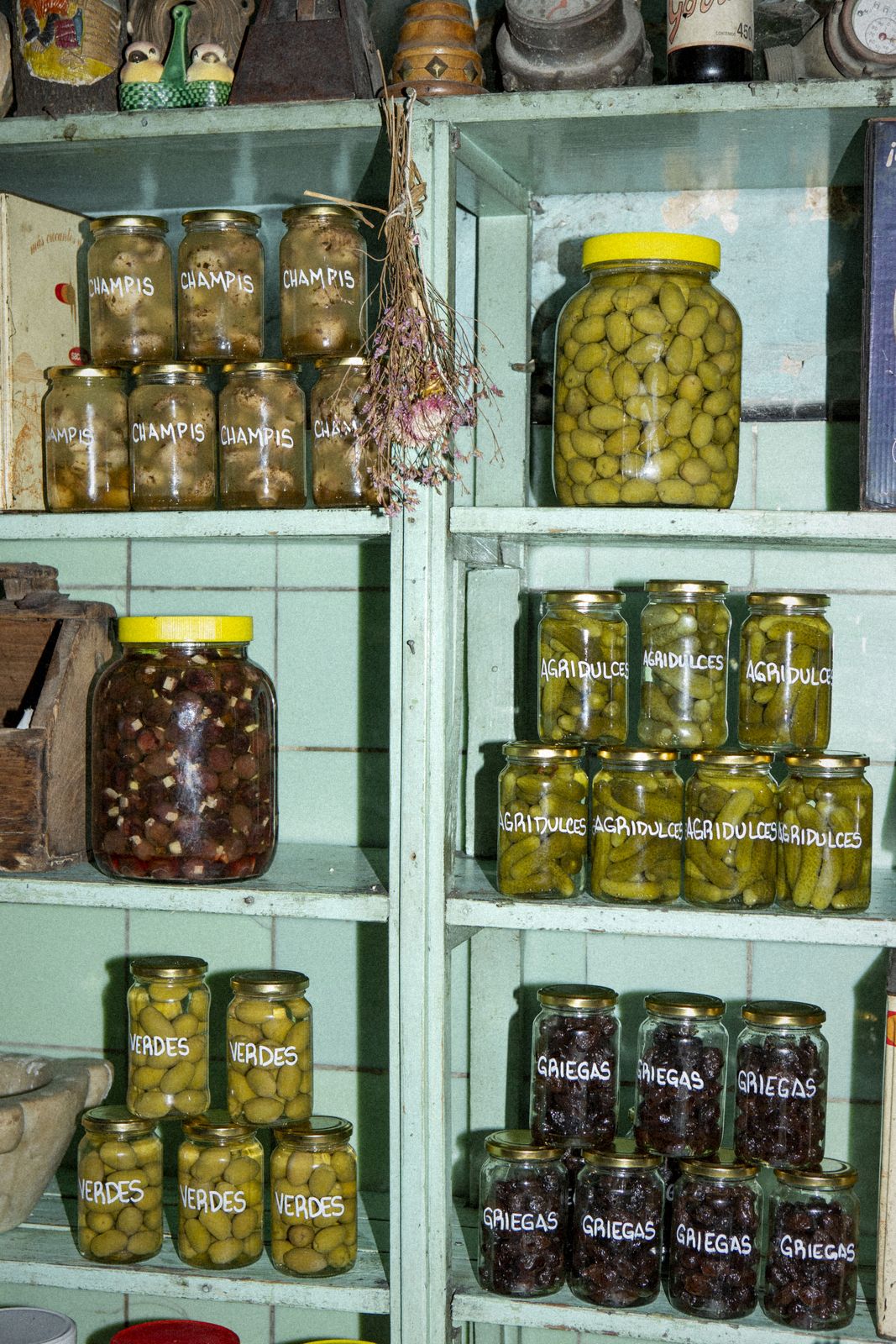 Jars of olives and pickles on shelves